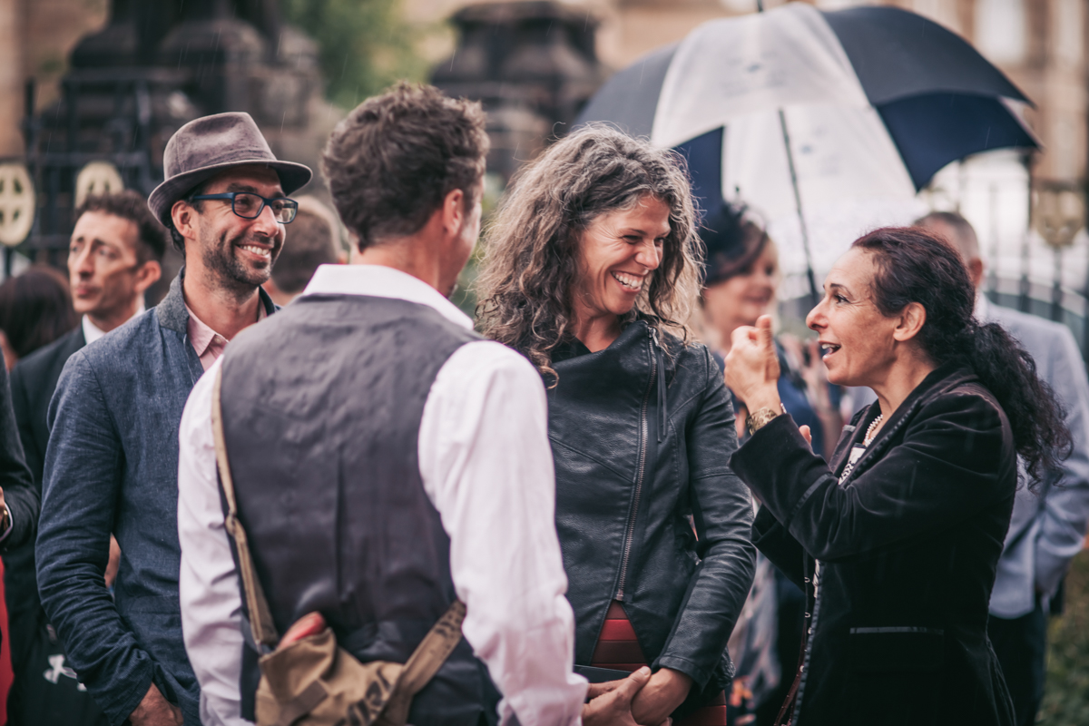 Wedding guest mingling outside venue after the wedding. Wedding guest mingling outside venue after the wedding.