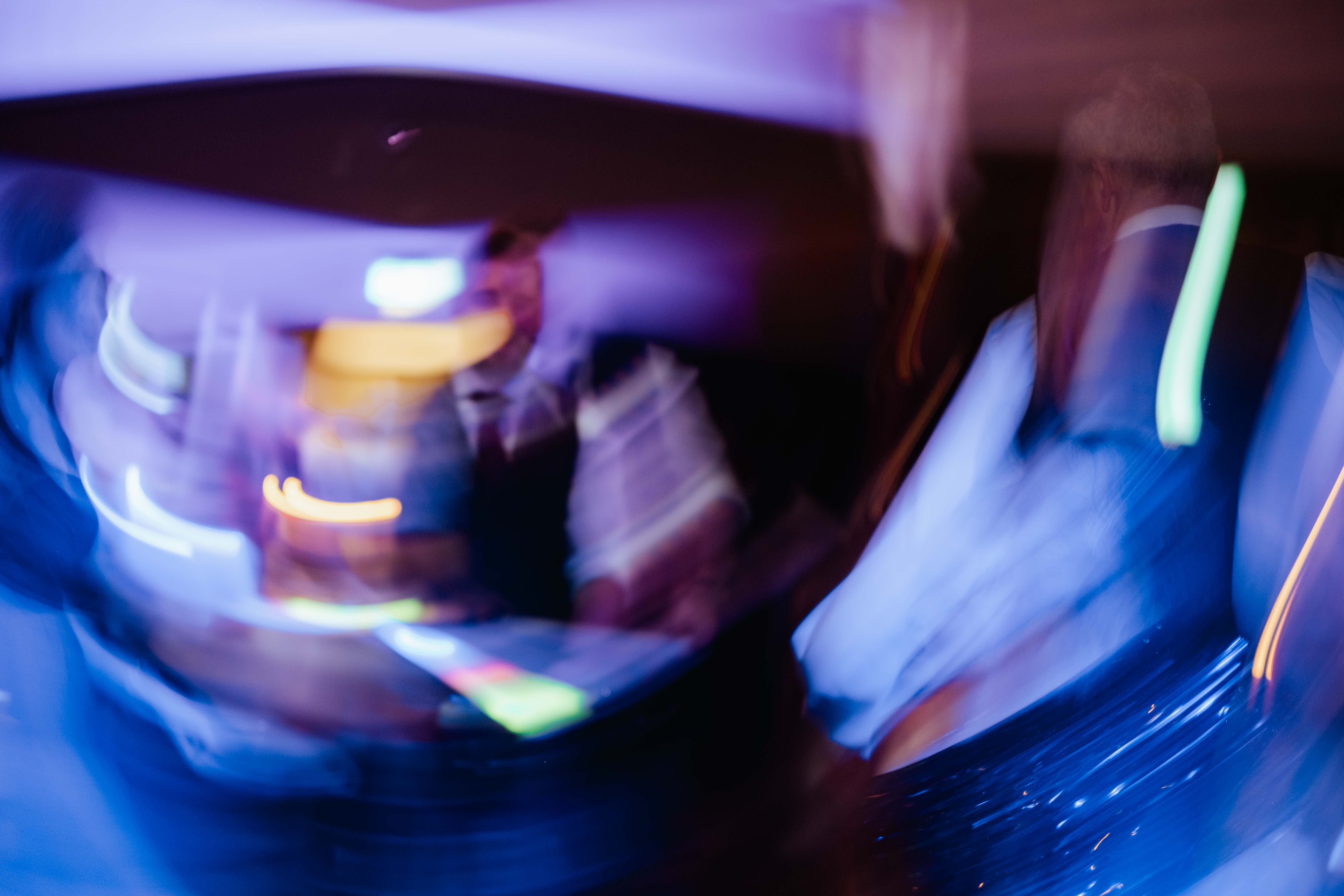 Groom dancing at wedding, slow shutter speed, light trails. Groom dancing at wedding, slow shutter speed, light trails.