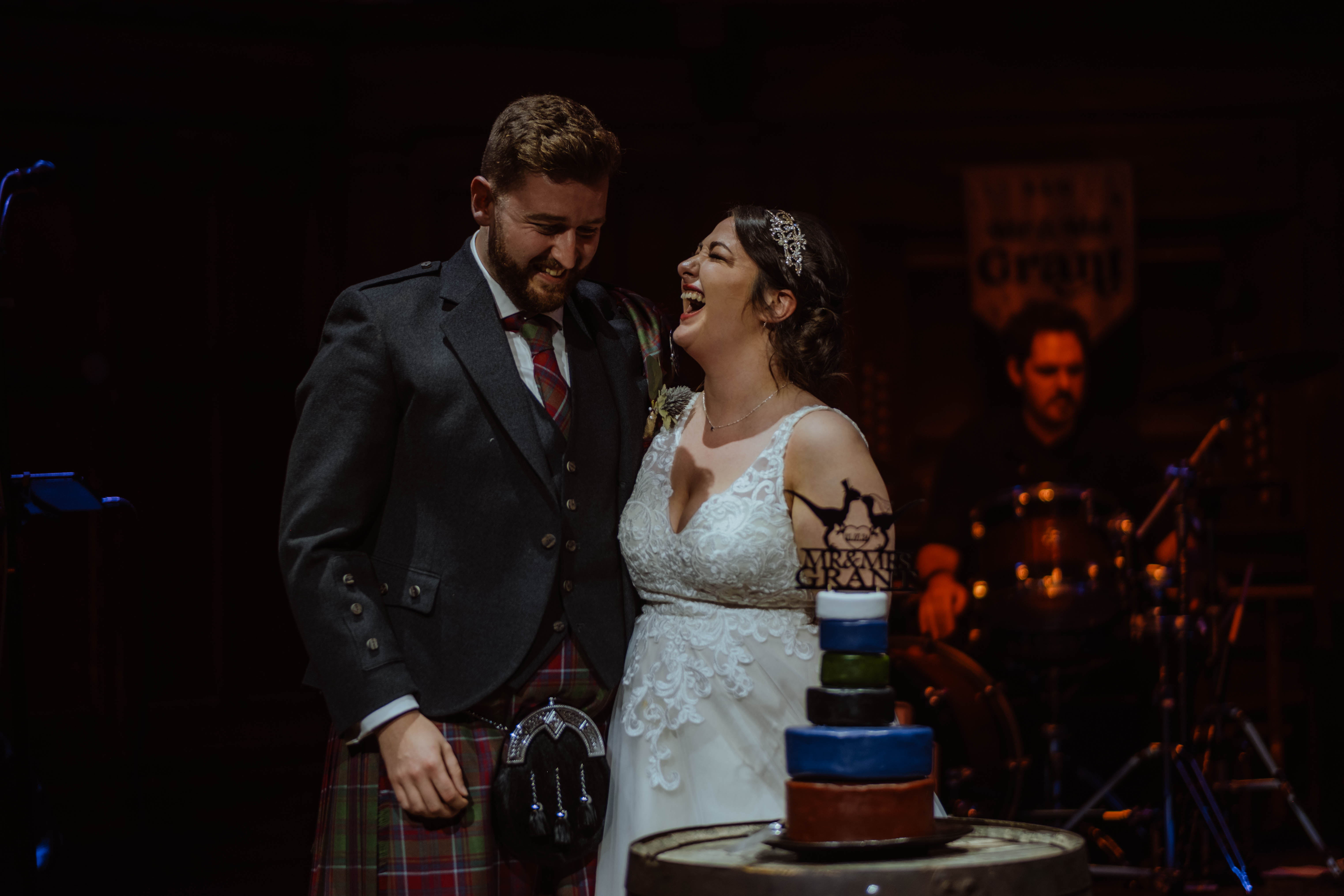 Bride and groom cutting cake during evening reception, St. Luke's, Glasgow Bride and groom cutting cake during evening reception, St. Luke's, Glasgow