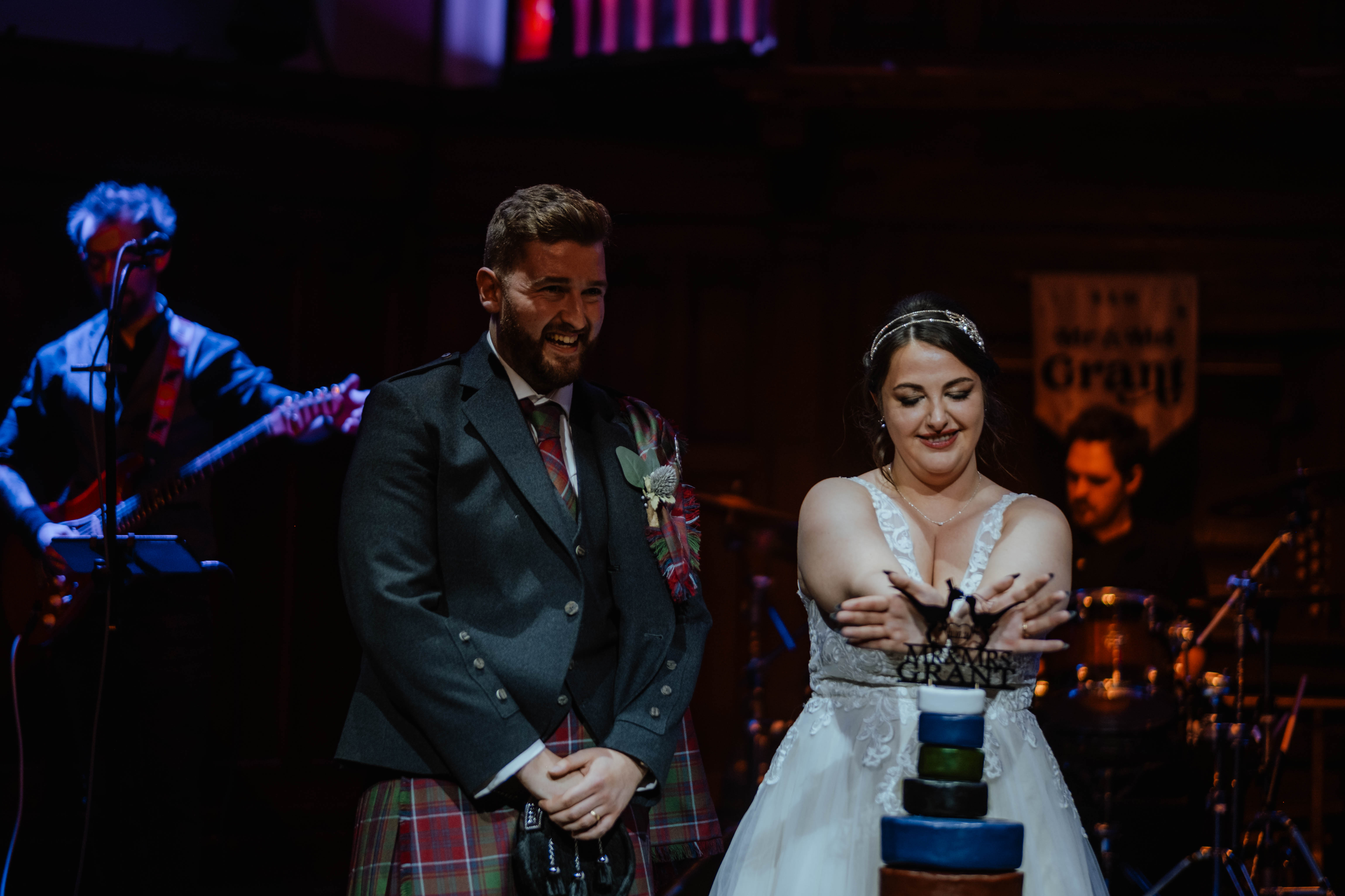 Bride and groom cutting cake during evening reception, St. Luke's, Glasgow Bride and groom cutting cake during evening reception, St. Luke's, Glasgow