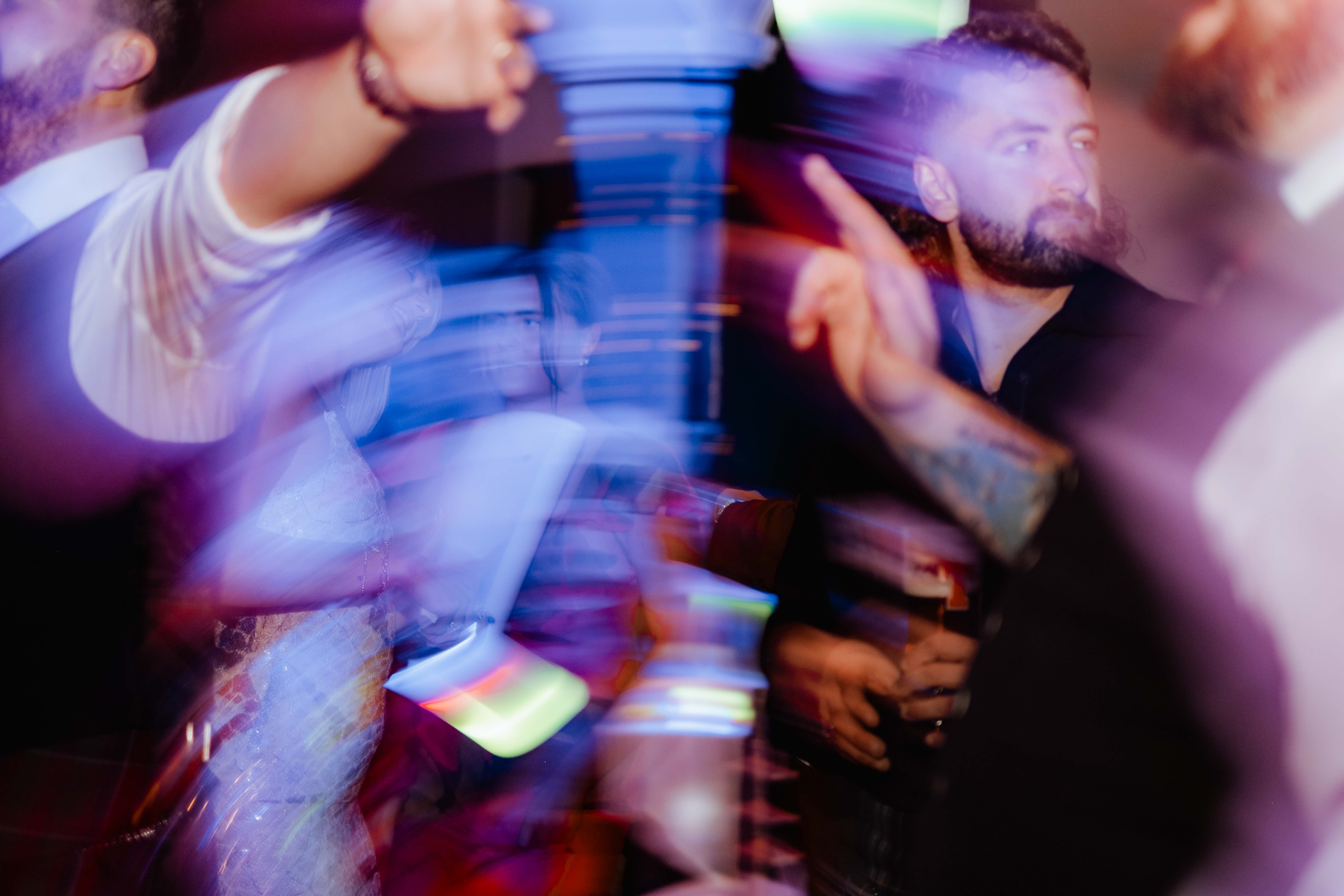 Wedding guests dancing, slow shutter speed, light trails. Wedding guests dancing, slow shutter speed, light trails.