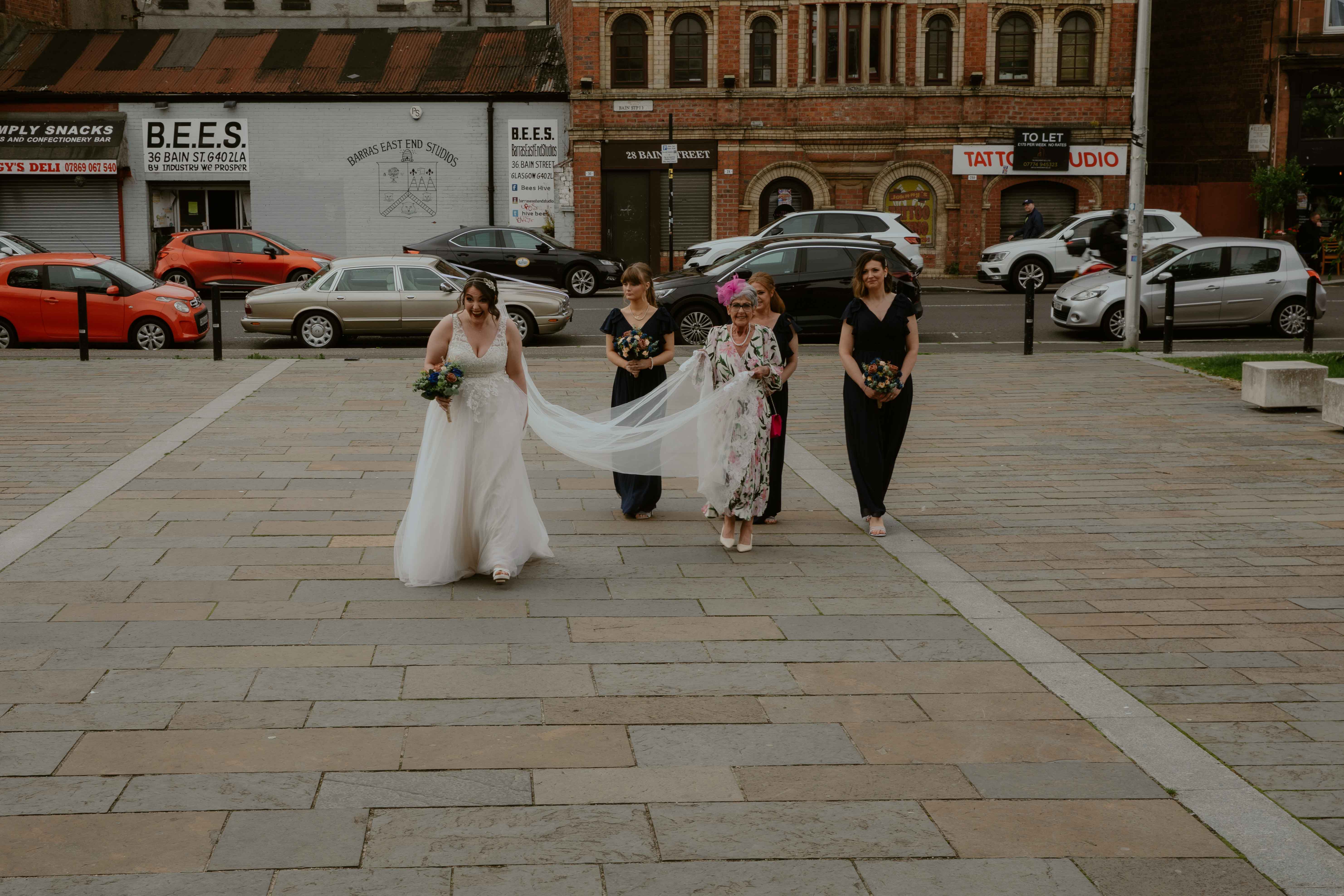 Bride, mother of the bride and bridesmaids heading from wedding car to wedding venue, Glasgow. Bride, mother of the bride and bridesmaids heading from wedding car to wedding venue, Glasgow.
