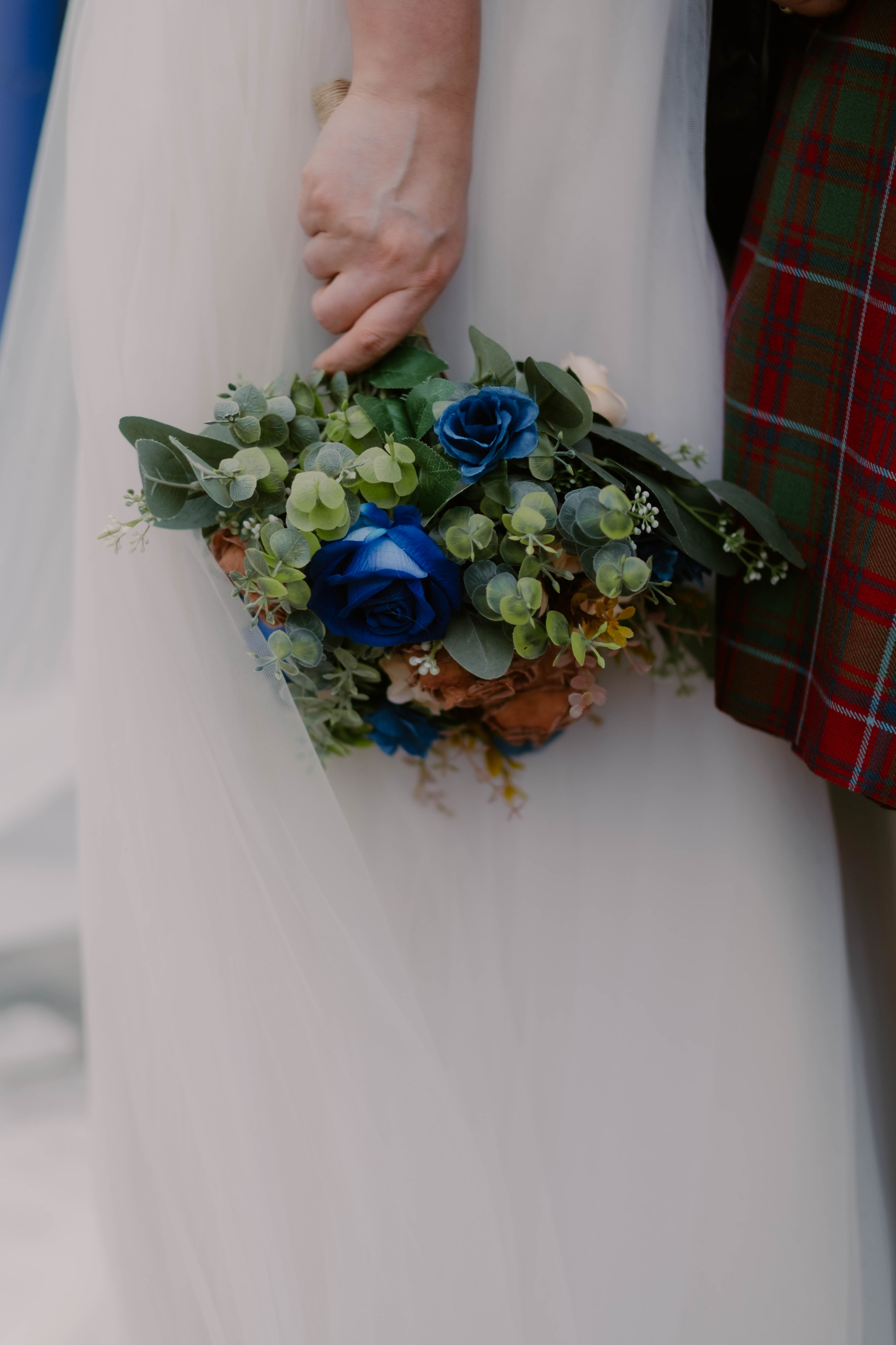 Bride holding bouquet near Glasgow Green, during couple portraits on wedding day. Bride holding bouquet near Glasgow Green, during couple portraits on wedding day.