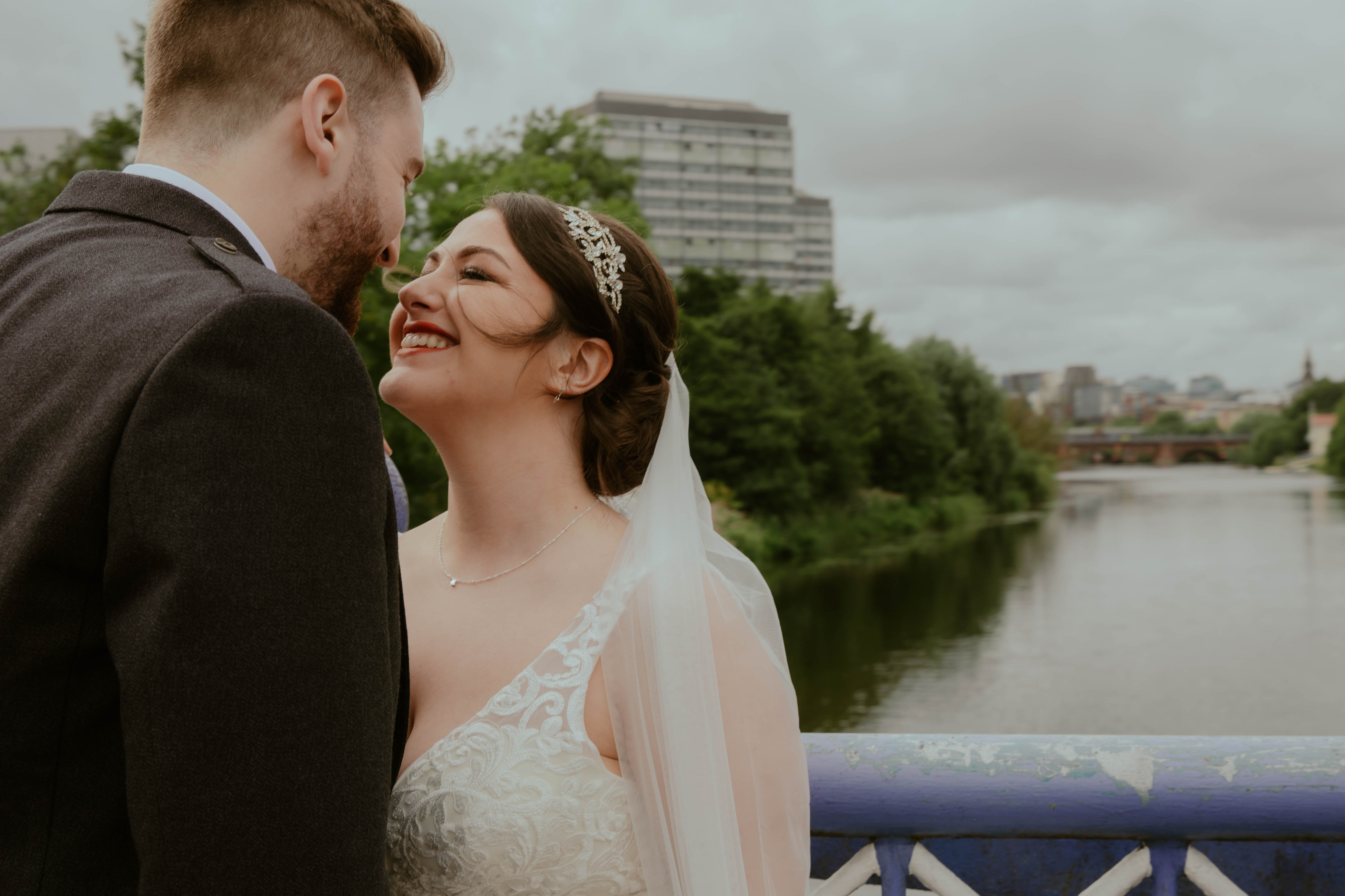 Bride and groom nose to nose on bridge near wedding venue, Saint Luke's, Glasgow. Bride and groom nose to nose on bridge near wedding venue, Saint Luke's, Glasgow.
