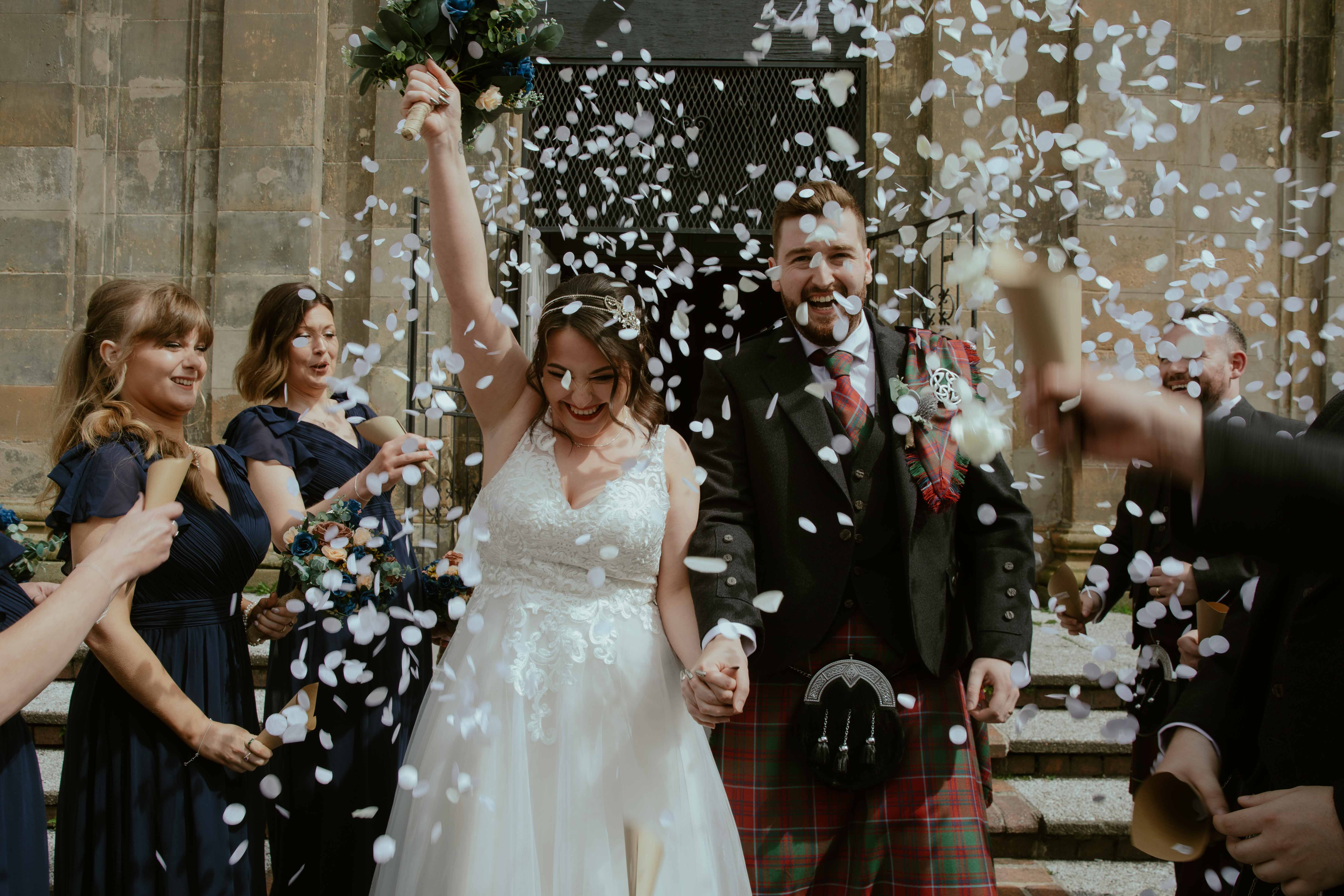 Confetti shot of bride and groom on the steps of Saint Luke's, Glasgow. Confetti shot of bride and groom on the steps of Saint Luke's, Glasgow.