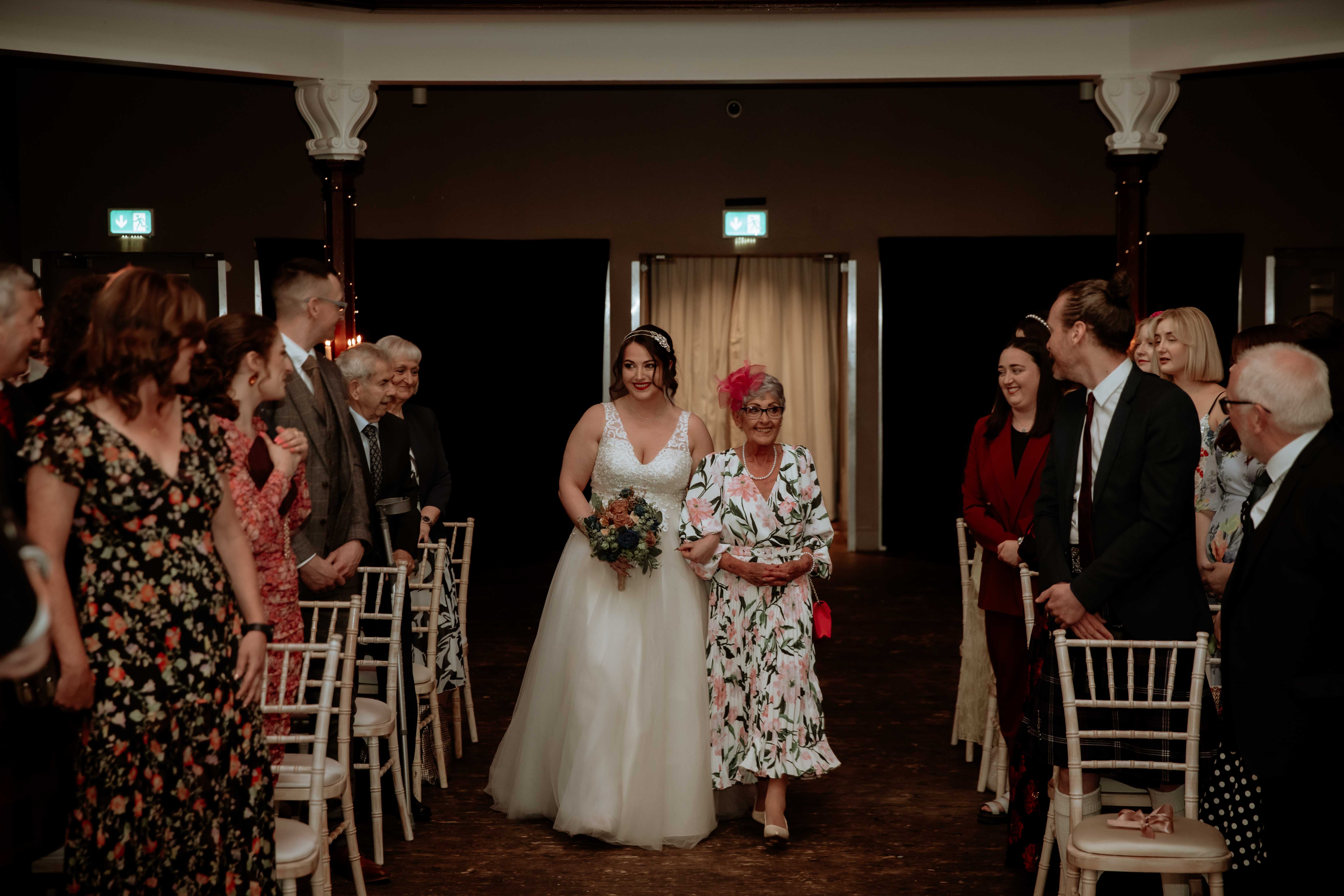Bride and mother of the bride walking down the aisle in Saint Luke's, Glasgow. Bride and mother of the bride walking down the aisle in Saint Luke's, Glasgow.