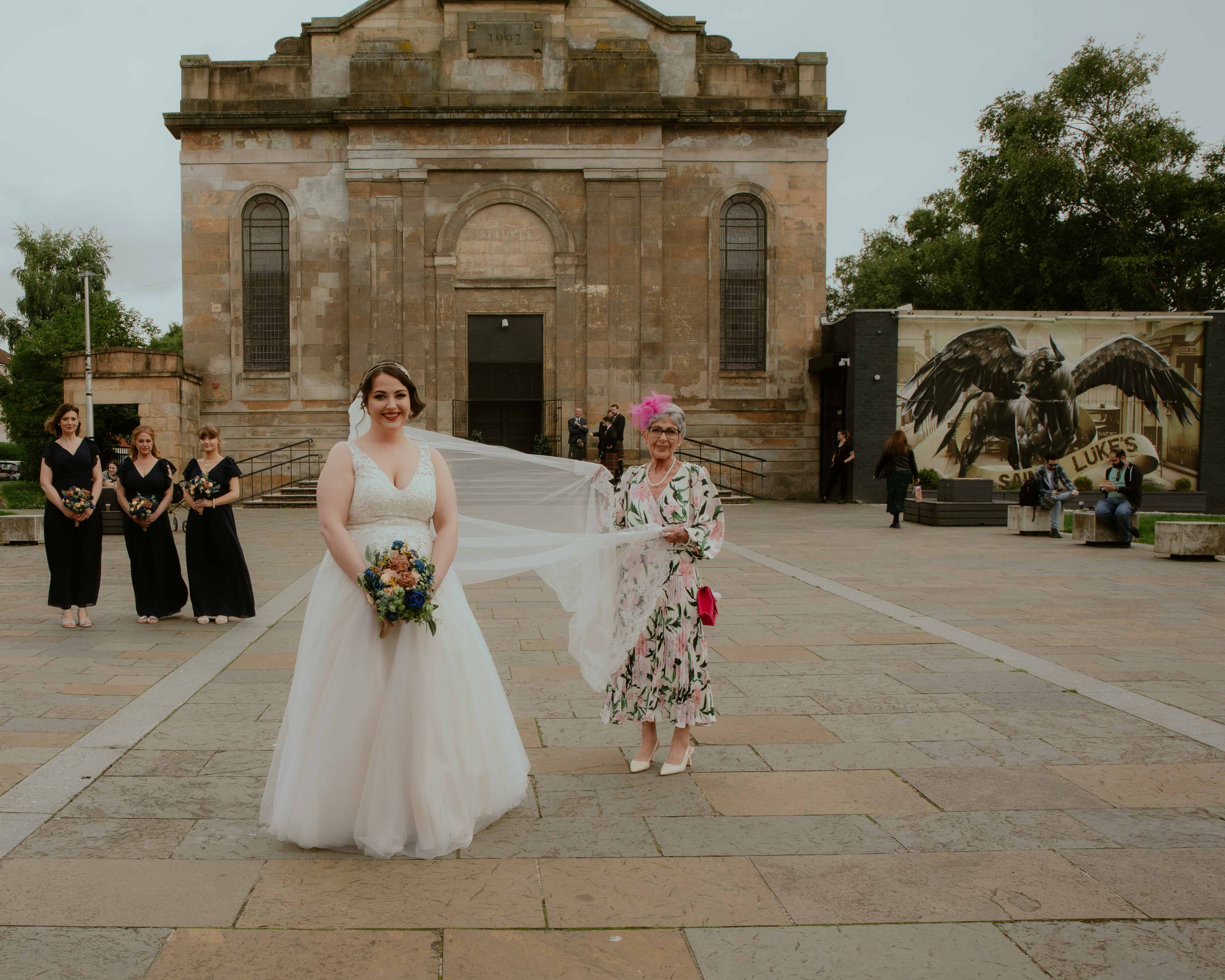 Bride, mother of the bride and bridesmaids outside wedding venue before wedding ceremony, St Luke's, Glasgow Bride, mother of the bride and bridesmaids outside wedding venue before wedding ceremony, St Luke's, Glasgow