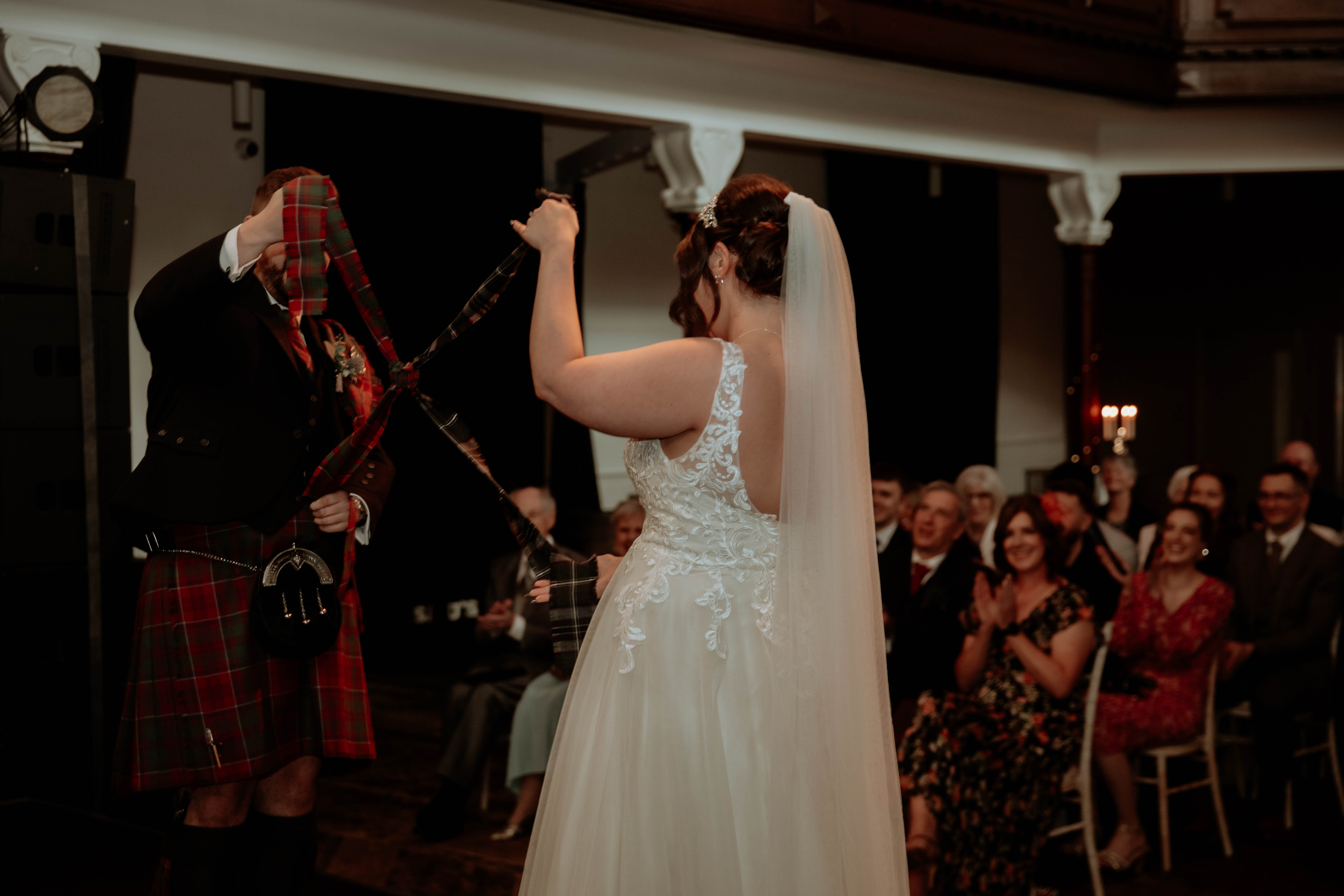 Bride and groom tied the knot after handfasting during wedding ceremony, St. Luke's, Glasgow. Bride and groom tied the knot after handfasting during wedding ceremony, St. Luke's, Glasgow.