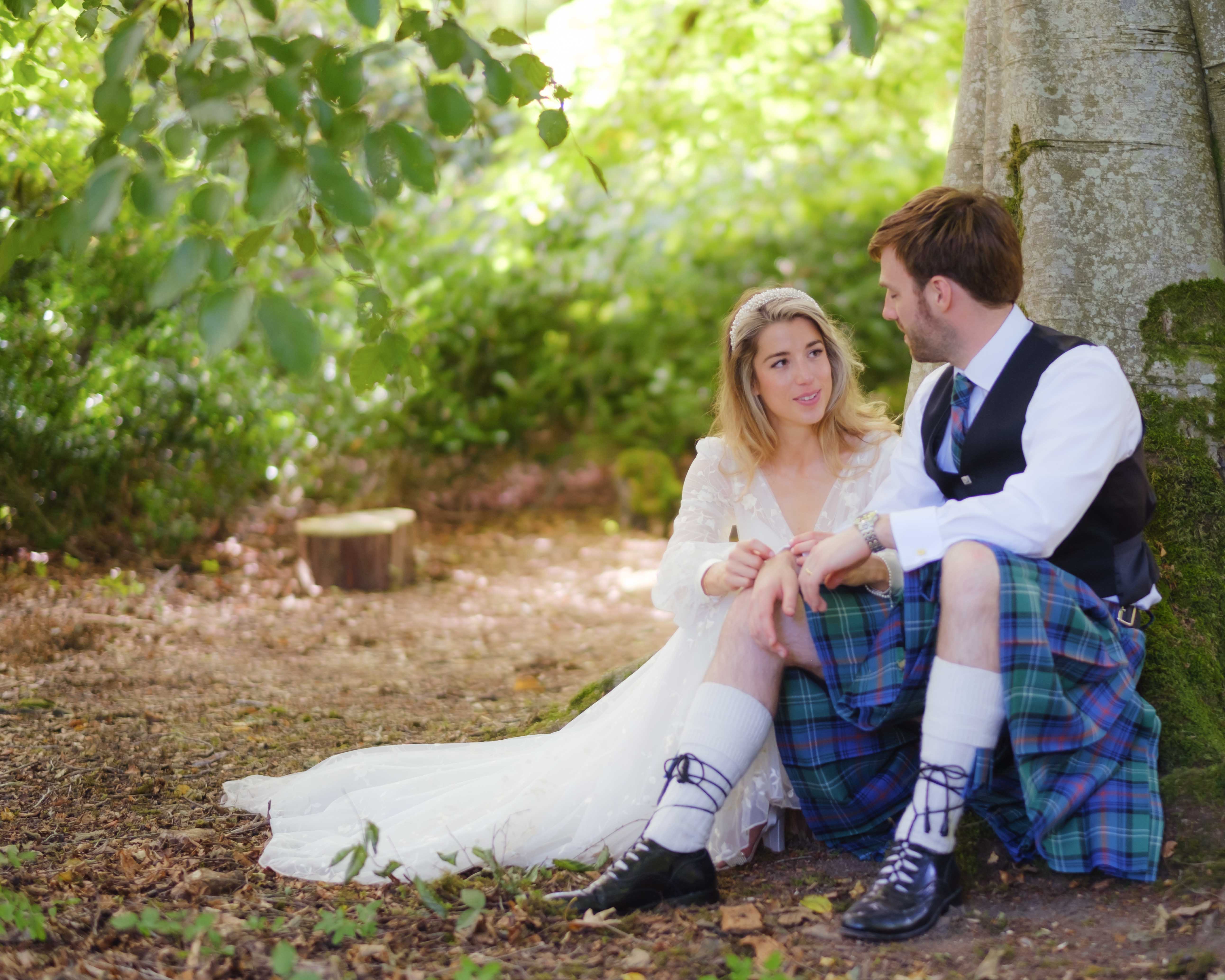 Bride and groom reflecting on their wedding ceremony, sitting under a tree in grounds of Kippilaw House. Bride and groom reflecting on their wedding ceremony, sitting under a tree in grounds of Kippilaw House.