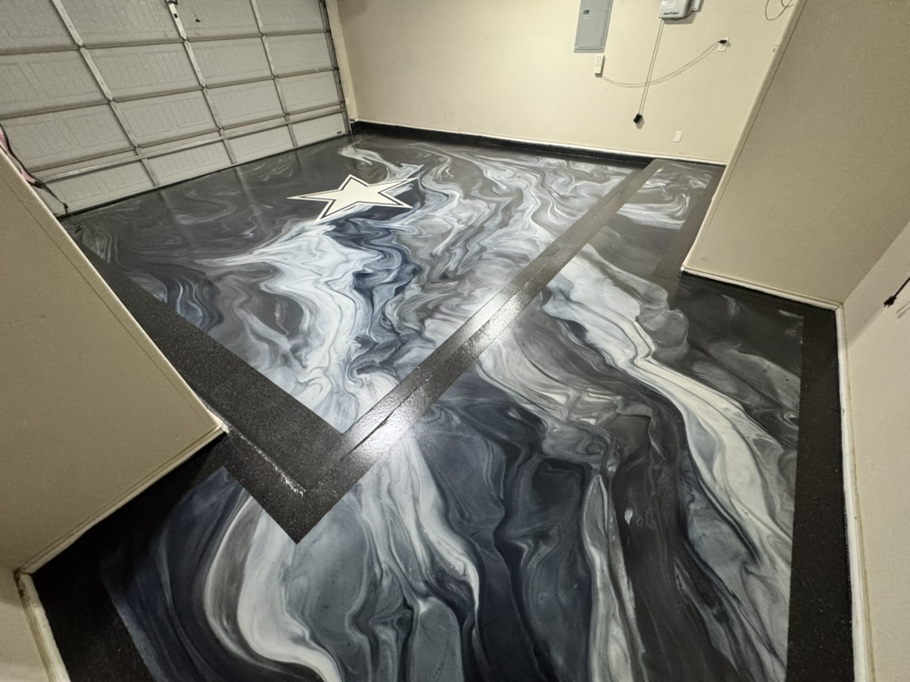 Custom metallic epoxy garage floor with black stone flake border in Midland Texas