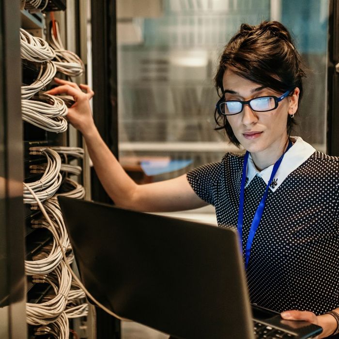 woman fixing computer woman fixing computer