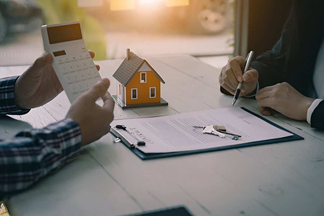 Two hands shaking, with a model house and calculator, symbolizing successful owner financing homes from KBR Investing. Two hands shaking, with a model house and calculator, symbolizing successful owner financing homes from KBR Investing.