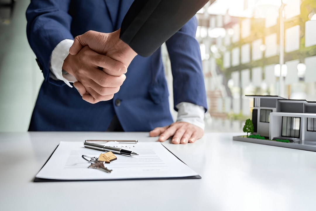  A handshake over a contract and house model, symbolizing how to Buy a house with owner financing from KBR Investing.