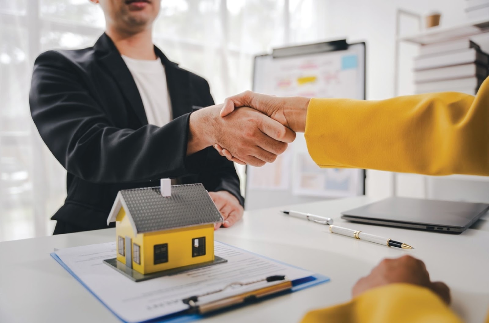 A handshake over a house model and contract represents KBR Investing, offering Owner financing for people denied by banks. A handshake over a house model and contract represents KBR Investing, offering Owner financing for people denied by banks.