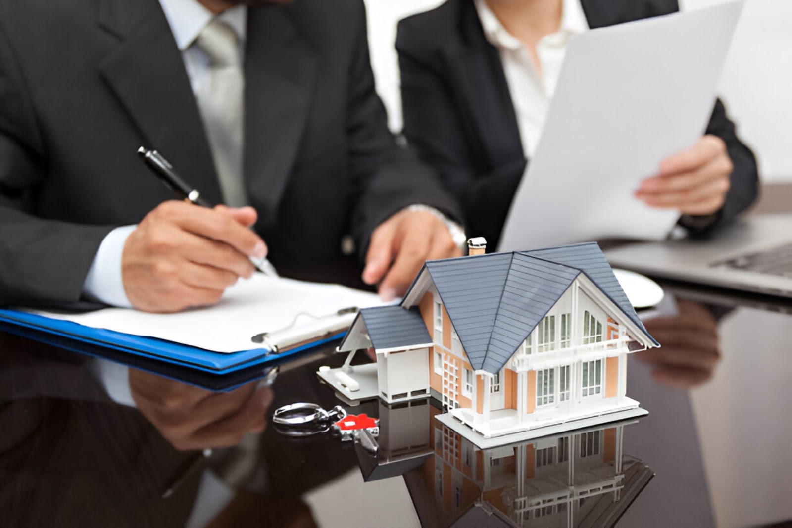 A hand reaches for a burlap sack with a question mark next to a house model, representing Owner financing for self-employed individuals through KBR Investing. A hand reaches for a burlap sack with a question mark next to a house model, representing Owner financing for self-employed individuals through KBR Investing.