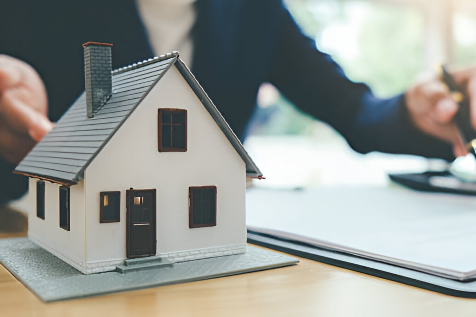 A real estate agent assists a couple viewing a house, highlighting Owner financing for self-employed individuals via KBR Investing. A real estate agent assists a couple viewing a house, highlighting Owner financing for self-employed individuals via KBR Investing.