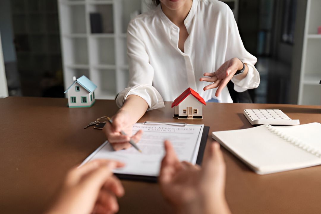 A couple and a real estate agent at a table with papers and a house model, discussing Qualifying for owner financing with KBR Investing. A couple and a real estate agent at a table with papers and a house model, discussing Qualifying for owner financing with KBR Investing.