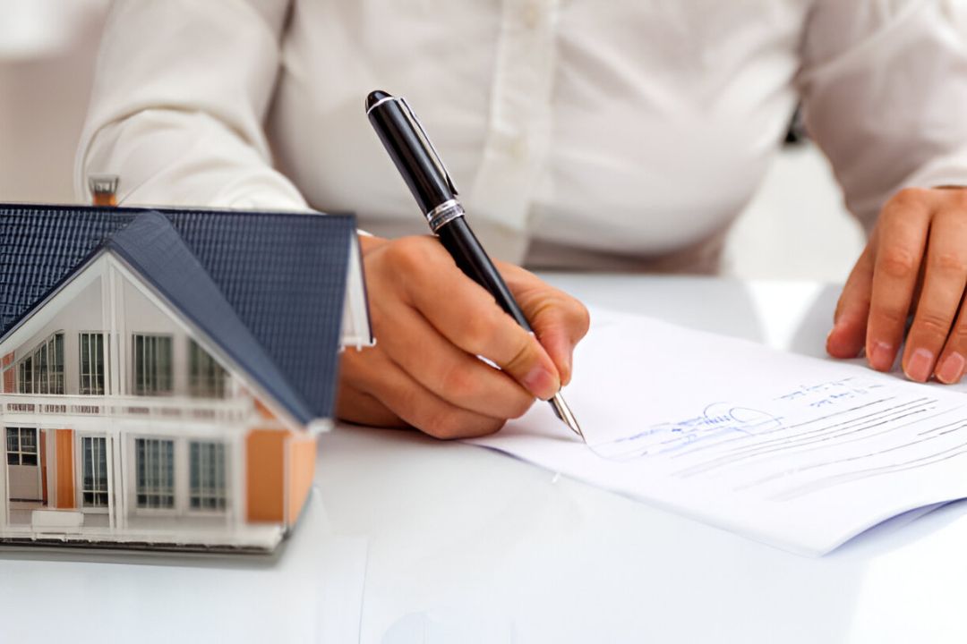 A businesswoman signing documents beside a house model, representing services for KBR Investing's Penalty box buyers. A businesswoman signing documents beside a house model, representing services for KBR Investing's Penalty box buyers.