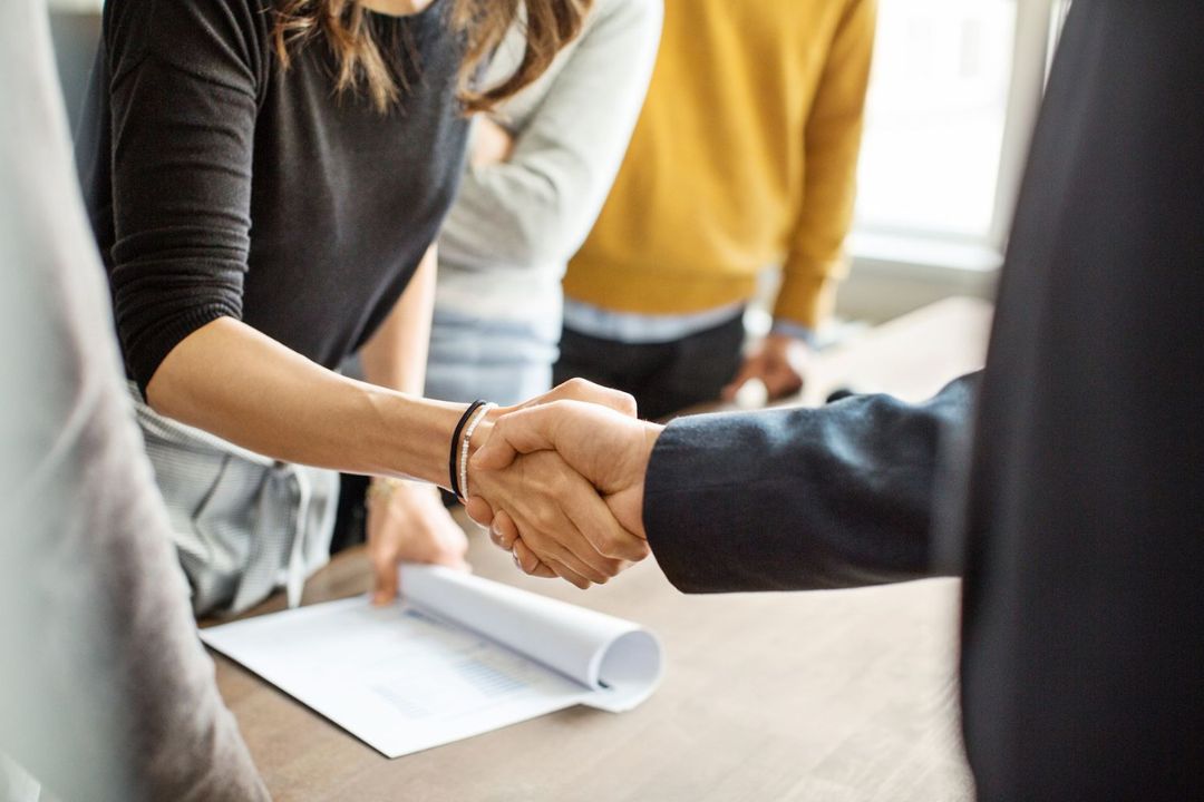 A businessman discusses with a client, clarifying Owner financing options at KBR Investing.