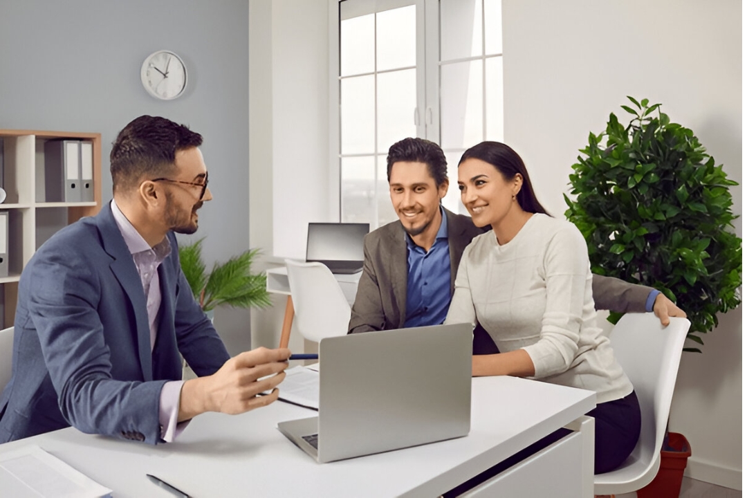 A smiling agent handing keys to a client, illustrating how to Buy a home without a bank through KBR Investing. A smiling agent handing keys to a client, illustrating how to Buy a home without a bank through KBR Investing.