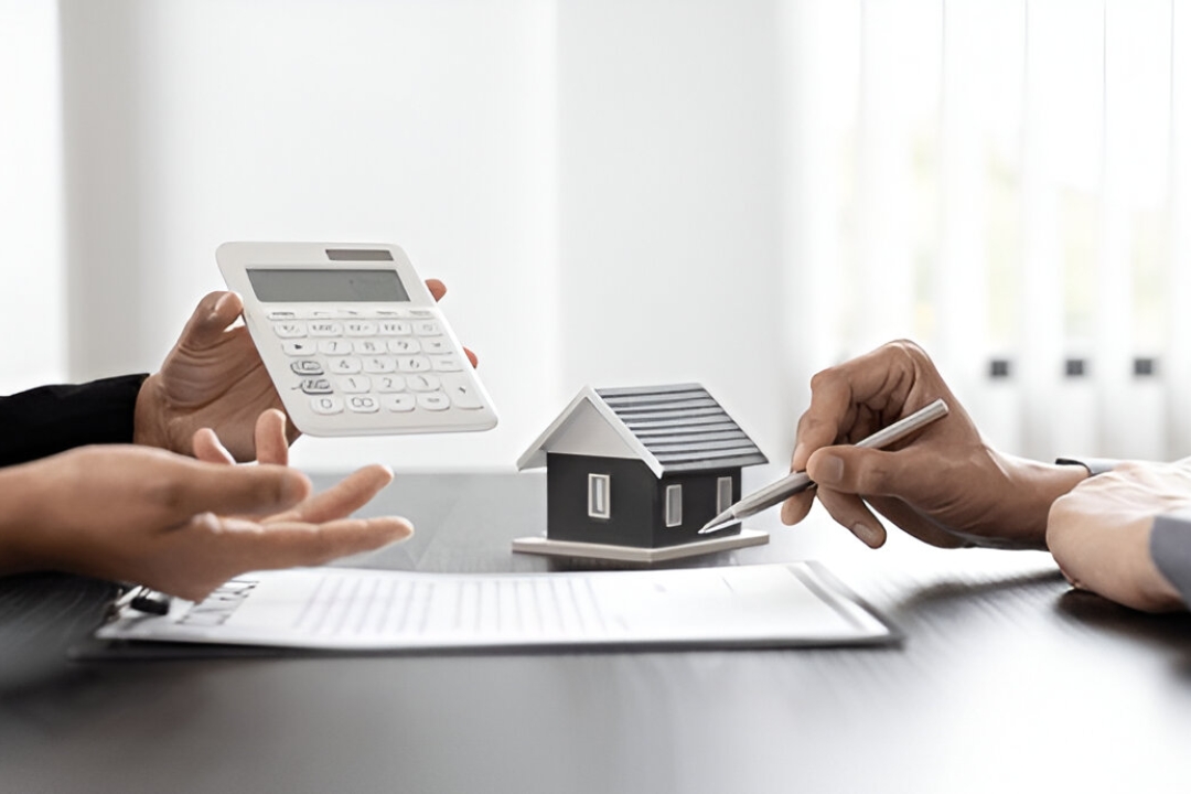  A house model and keys are on a table with a calculator, aiding in finding No credit check homes from KBR Investing.
