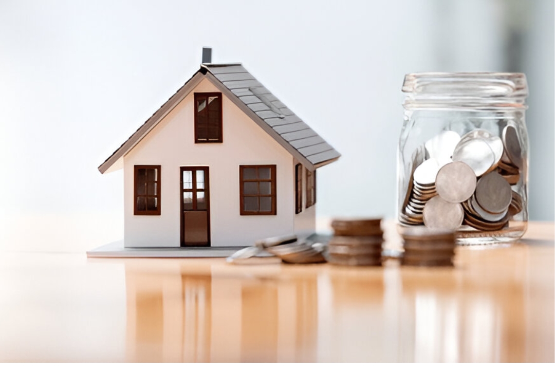 A white house model sits next to a glass jar filled with coins, representing No bank mortgage alternatives from KBR Investing. A white house model sits next to a glass jar filled with coins, representing No bank mortgage alternatives from KBR Investing.