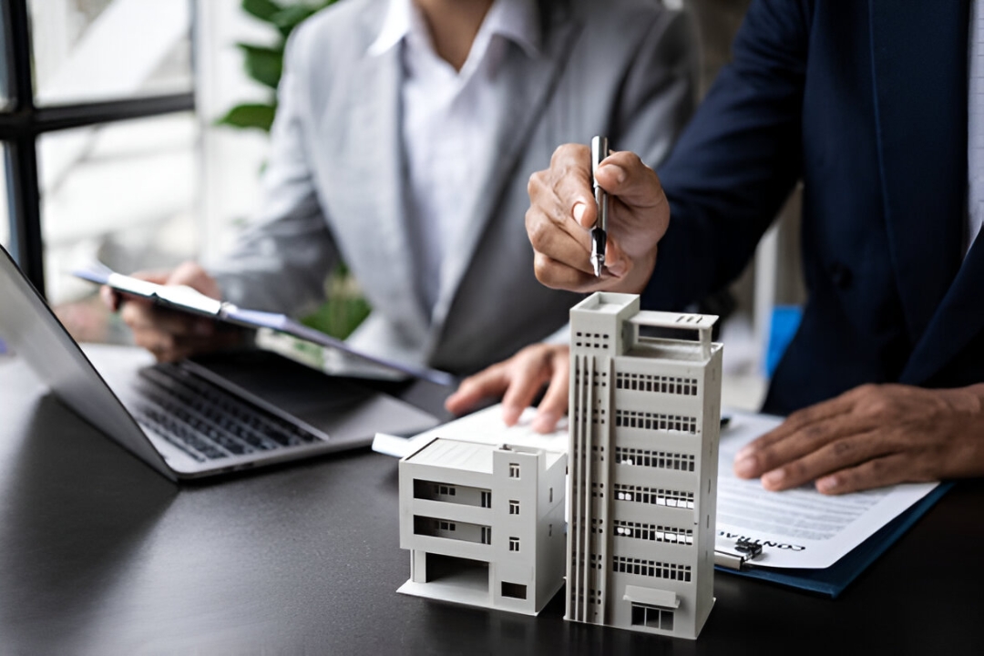 A businessman's hands point to a small house model, keys, and documents, illustrating how to Buy a home with no credit score from KBR investing. A businessman's hands point to a small house model, keys, and documents, illustrating how to Buy a home with no credit score from KBR investing.
