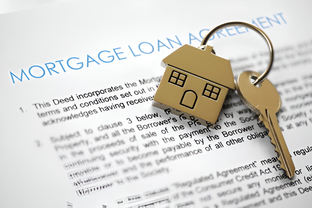 Keys and a house keychain atop a mortgage loan agreement, illustrating information about Qualifying for owner financing loans with KBR investing.