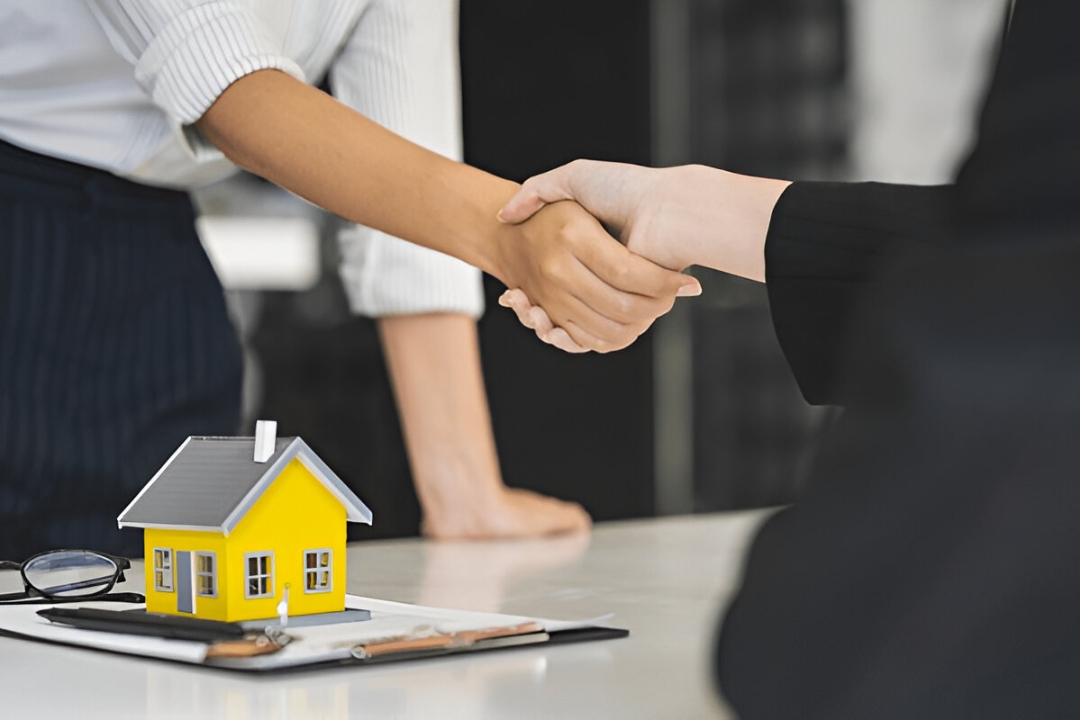  A handshake over a contract and house model shows Kbr investing's solutions for Home buying options for penalty box buyers.