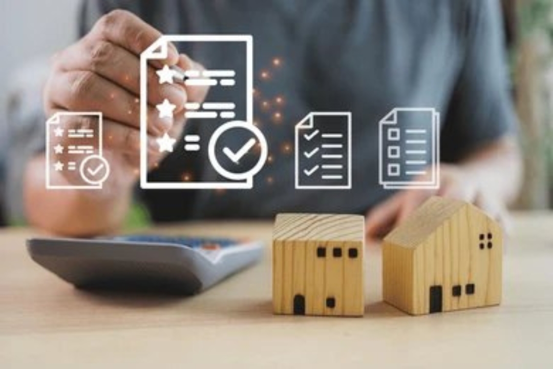 A hand interacts with digital document icons above miniature houses and a calculator, illustrating Kbr investing's Homes for sale with owner financing process.
