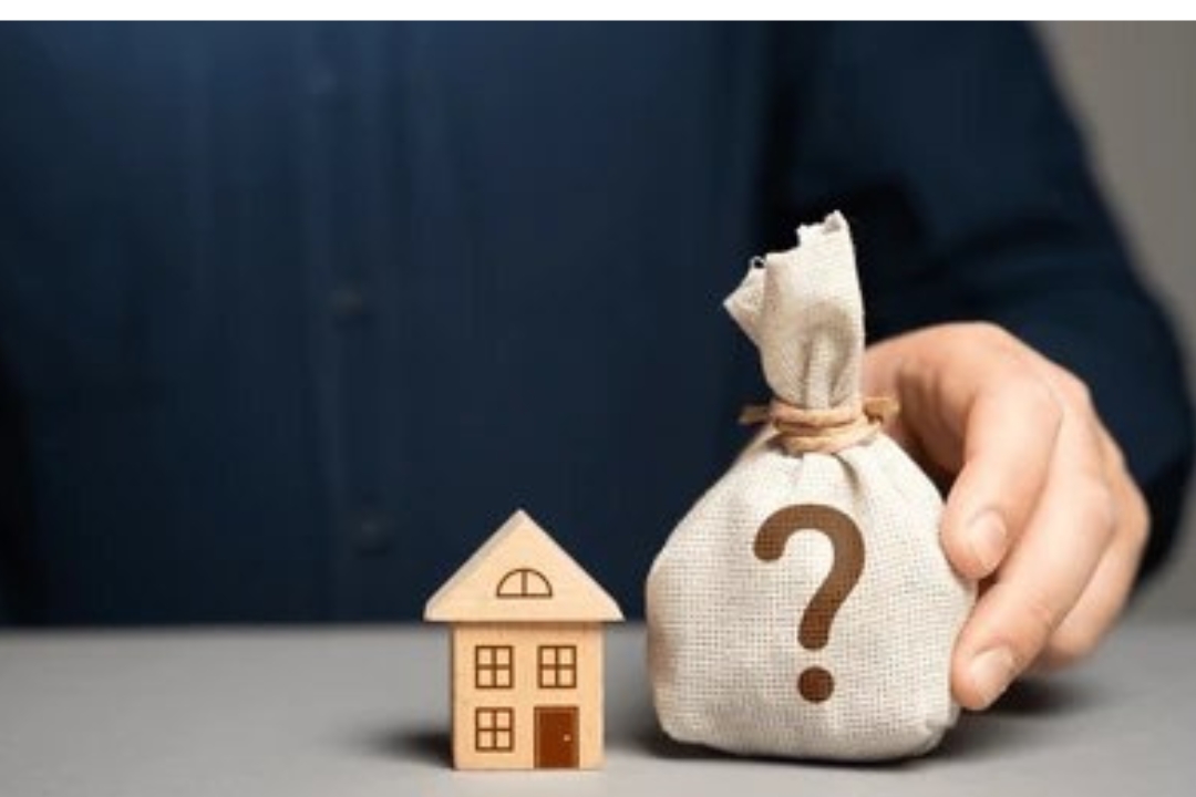 A small wooden house and a money bag with a question mark, representing inquiries about Homes for sale with owner financing from Kbr investing.