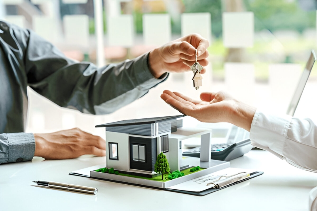 A hand gives house keys over a model home, illustrating Kbr investing's solutions to Buy a home without a loan.
