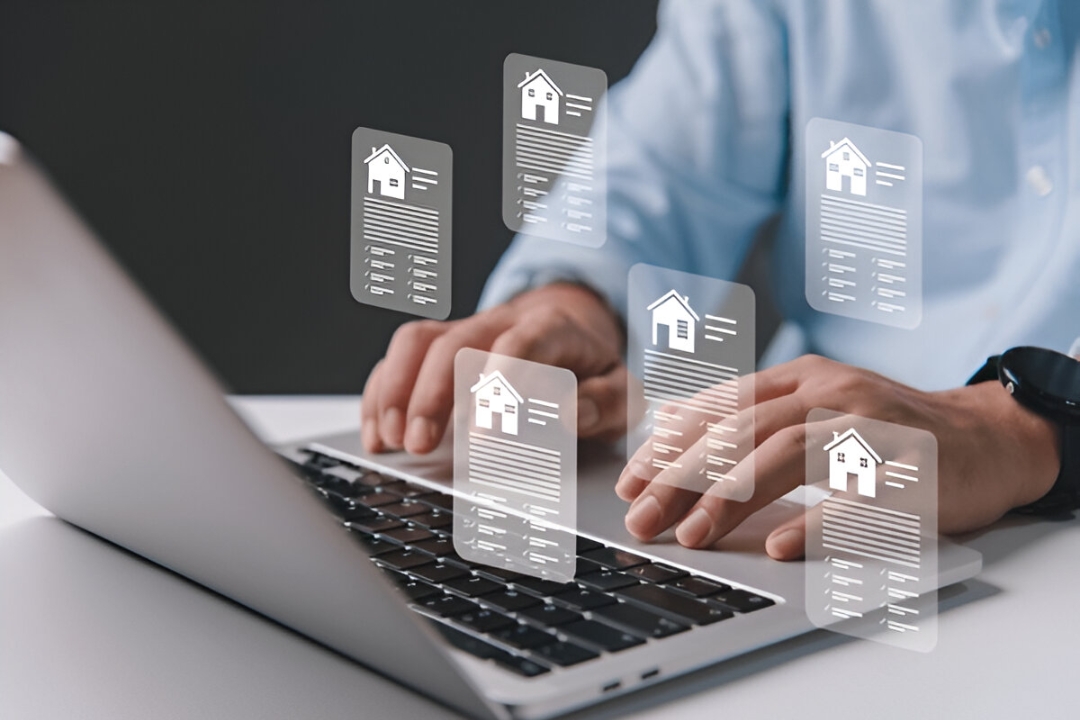 Person typing on a laptop with digital house icons floating, representing easy home financing options offered by KBR Investing online.