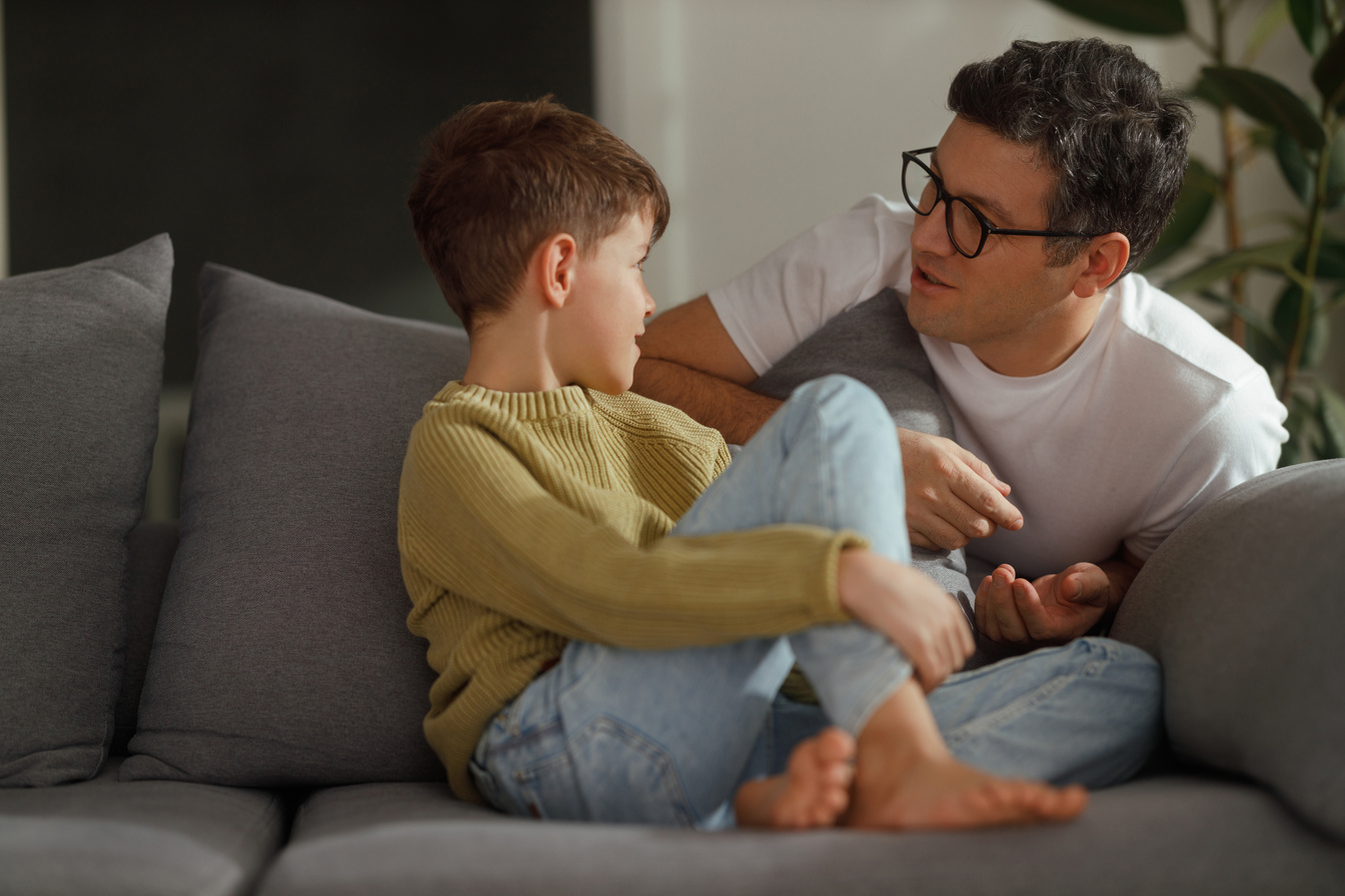 Father and son repair conversation on the couch Father and son repair conversation on the couch