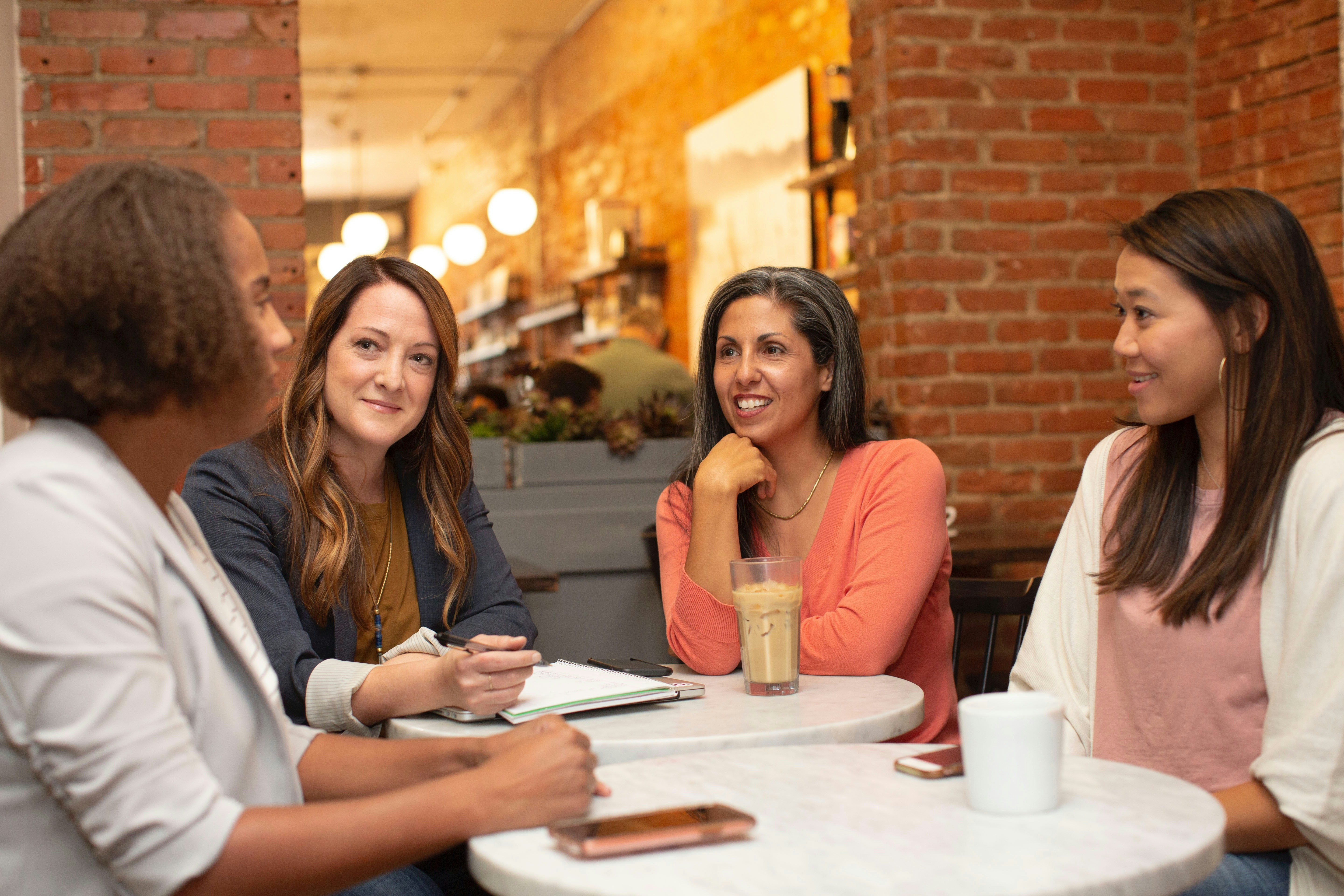 a group of women talking over coffee a group of women talking over coffee