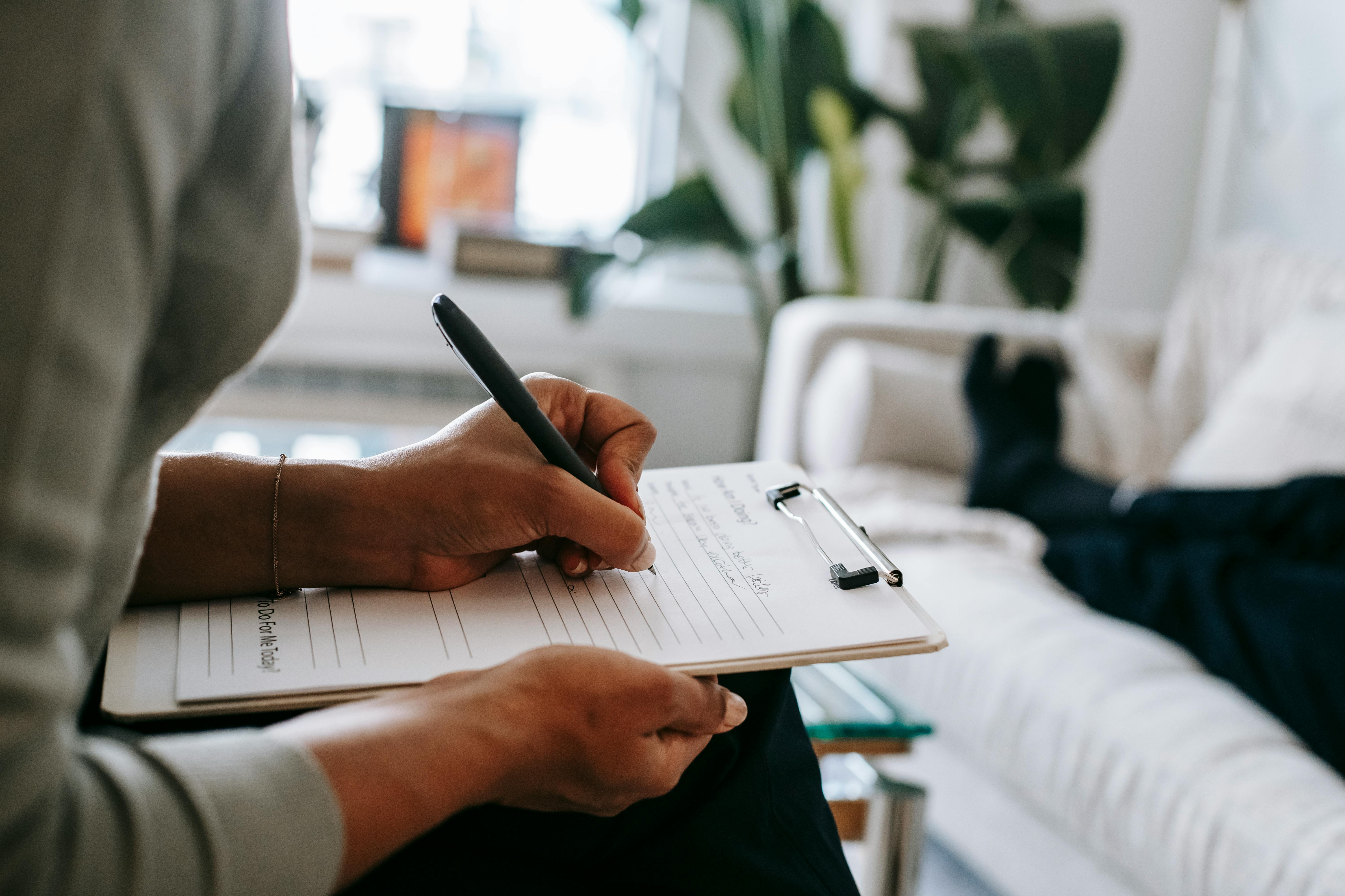 a therapist writing on a clipboard a therapist writing on a clipboard