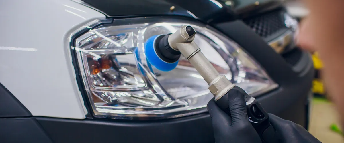 Buffing headlight during professional restoration service
