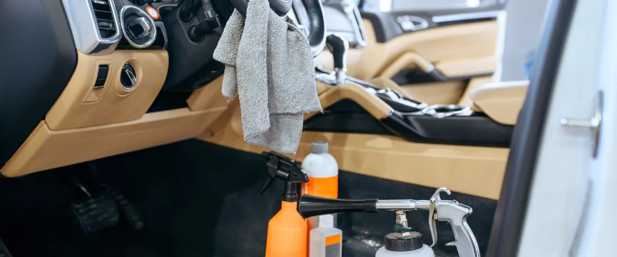 Interior detailing setup with spray bottles and cloths
