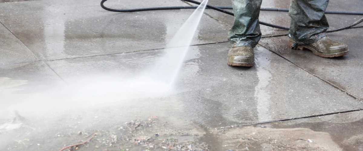 Pressure washing concrete sidewalk to remove dirt, stains, and debris Pressure washing concrete sidewalk to remove dirt, stains, and debris