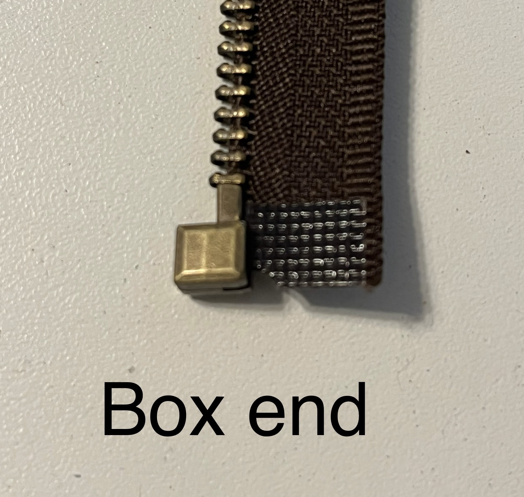 Box end of a zipper