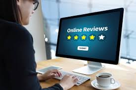 a person looking at a monitor that had the words online reviews on it