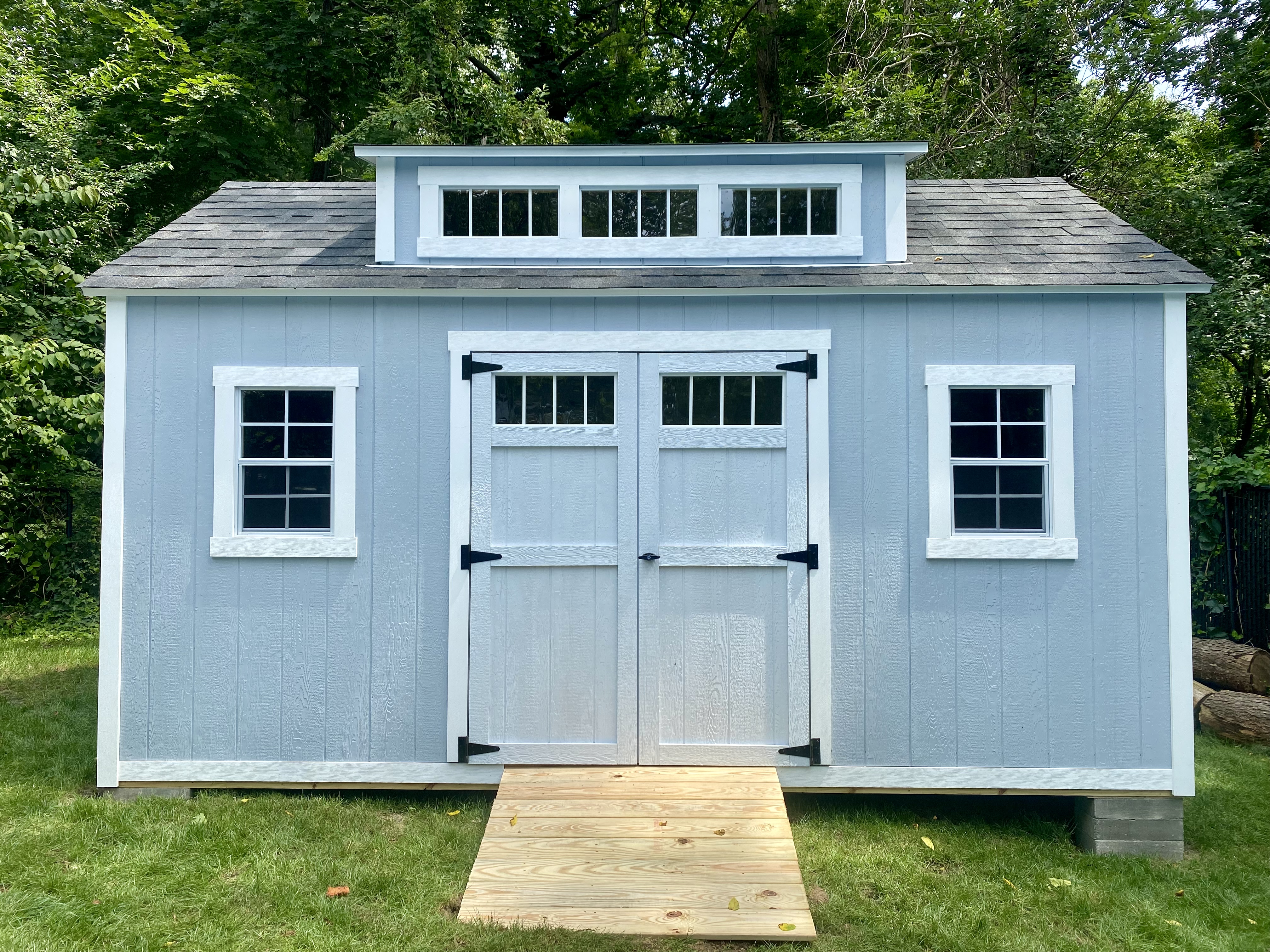 Custom transom door and dormer on outdoor portable building