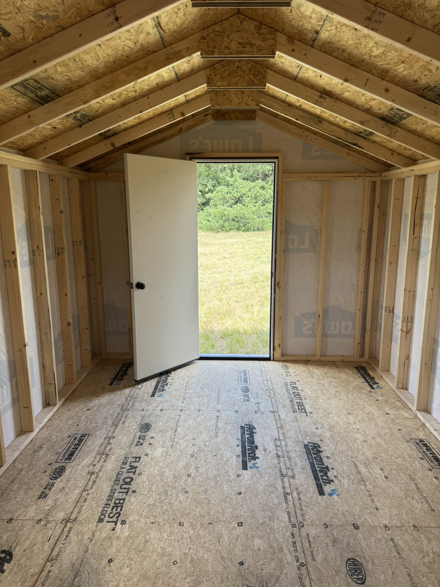 Outdoor shed with insulated door for home office or workshop Outdoor shed with insulated door for home office or workshop