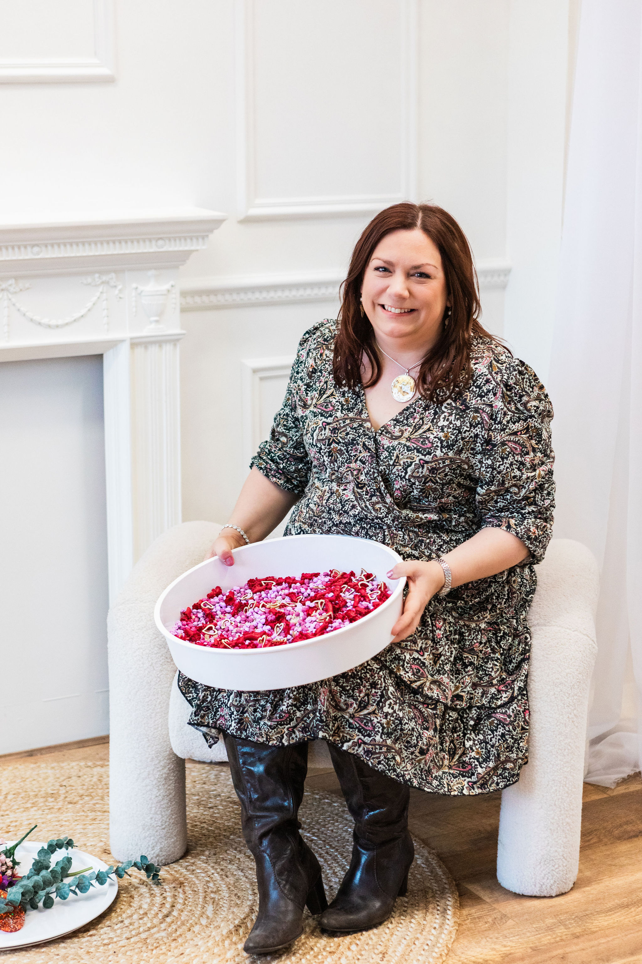 Sharon Graves, Founder of Time to Play Sensory sitting and smiling and showing a play tray featuring a themed pour-and-play sensory mix Sharon Graves, Founder of Time to Play Sensory sitting and smiling and showing a play tray featuring a themed pour-and-play sensory mix