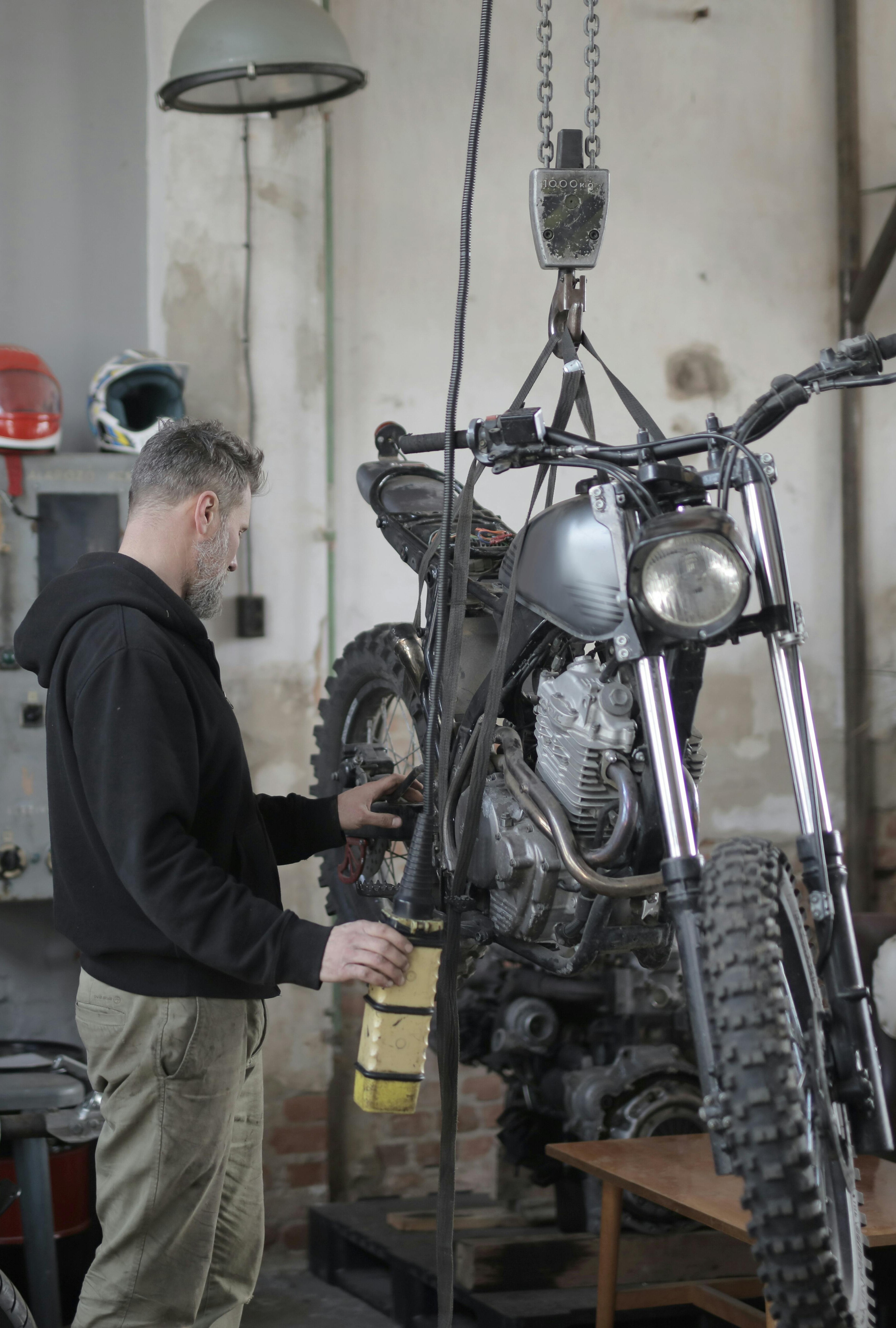 Spring motorcycle tune-up in Flagstaff Arizona garage with oil change and battery test