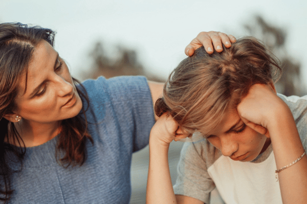 Parent comforting child frustrated by education Parent comforting child frustrated by education
