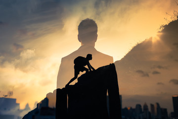 Transparent outline of a male in a suit with a background of a mountain. The image depicts a man climbing the mountain, symbolizing progress and leveling up to the next level.