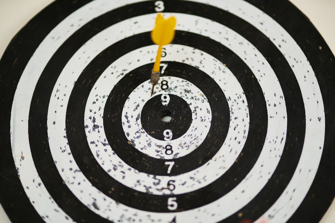 A target with a yellow dart A target with a yellow dart