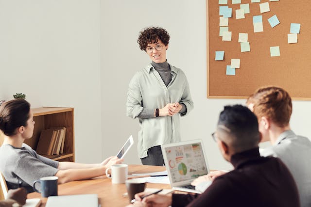 women wearing a gray sweater with glasses in a meeting women wearing a gray sweater with glasses in a meeting