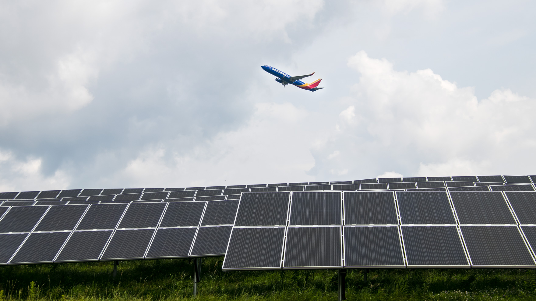 Airplane flying over solar array
